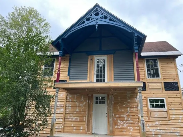 Before: Victorian home with bare, weathered cedar siding